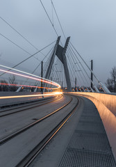 Tram lights trails on tram cable-stayed bridge in Krakow, Poland