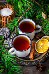 Two mugs of tea on vintage metal tray, christmas decoration.