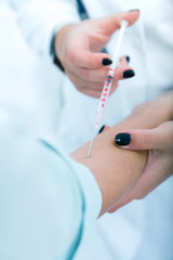 Doctor giving an injection to a patient..toned image.