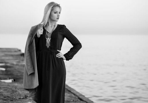 Fototapeta High fashion photo of elegant woman in black long dress and styl
