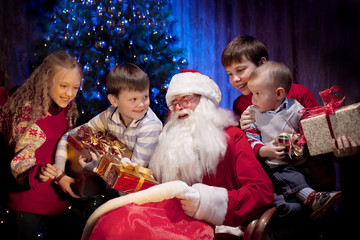 Santa giving Christmas Presents to Happy Children