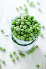 frozem peas on wooden surface