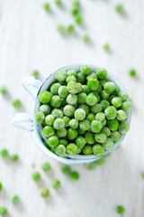 frozem peas on wooden surface