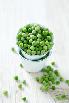 frozem peas on wooden surface