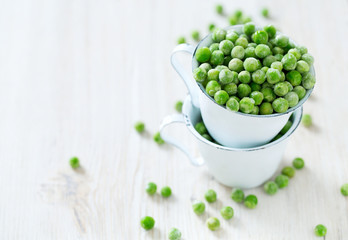 frozem peas on wooden surface