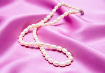 Pearls a necklace on a silk fabric