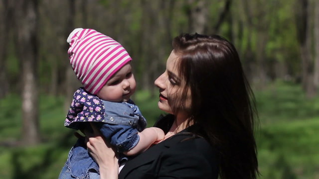 woman playing with her daughter and trying kissing girl