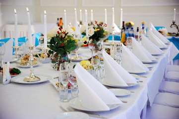 Festive table. Table setting. Festive round table with food.  Starched napkins and Cutlery. Festive meals. Restaurant inside. Service holidays. Вesign of the hall.