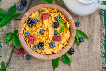 Tasty cornflakes with berry fruits and milk