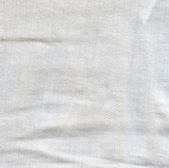Fototapeta na wymiar Light crumpled jeans background. Creased denim surface. White gr