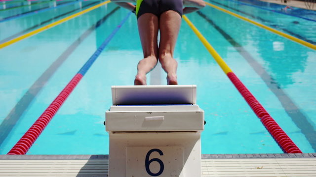 Professional Swimmer Diving from a Block in Extreme Slow Motion