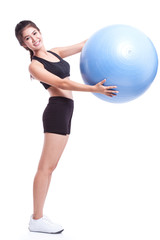 Young woman doing exercises with fitness ball.