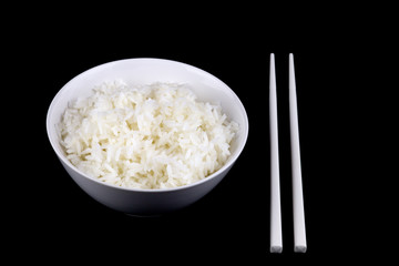 Steamed Rice In Bowl with Chopsticks on Black Background
