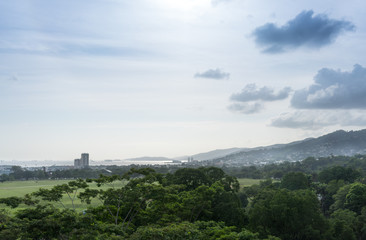 Distant view of city with mountain against cloudy sky, Trinidad, Trinidad And Tobago