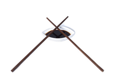 Pair of chopsticks and vlack oy sauce isolated on white backgrou