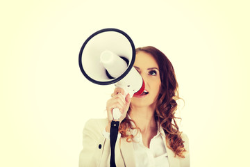 Businesswoman shouting with megaphone.