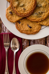 Fresh chocolate chip cookies on a wood background.