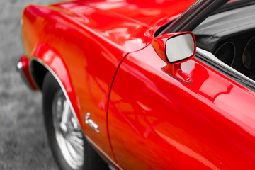 Plakat Close-up of wing mirror of a red shiny classic vintage car