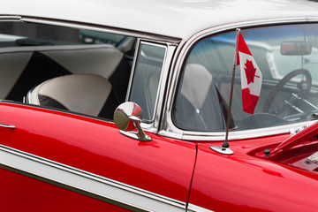 Canadian flag on bonnet of a red classic vintage car