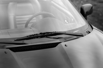 Windscreen wiper of a black shiny classic vintage car