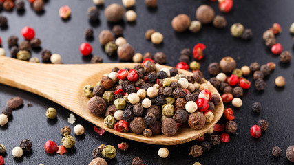Mixed peppers on a wooden spoon