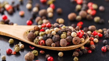 Mixed peppers on a wooden spoon