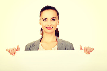 Fototapeta premium Business woman presenting empty banner.