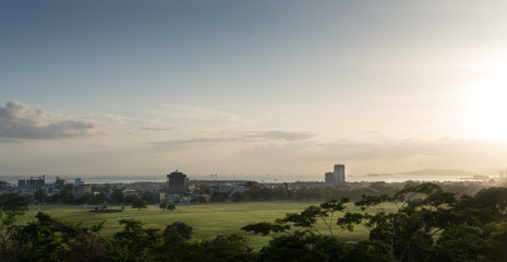 Naklejka na ściany i meble Distant view of city against cloudy sky, Trinidad, Trinidad And Tobago