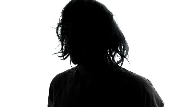 Mysterious Man in Silhouette with Long Messy Hairs and Rotating