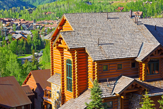 Telluride city panorama and mountain hillsides with coniferous forest. Beautiful town among the forest on a sunny day in Colorado, USA.