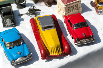 Variety of vintage toy cars on display at stall in flea market