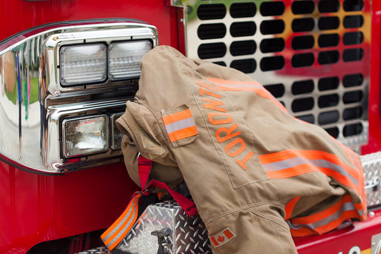 Close-up of rescue protective suit on bumper of fire vehicle
