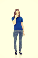 Disgusted teen covering her mouth.