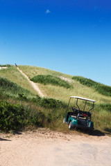 Golf cart parked on golf course, Prince Edward Island, Canada