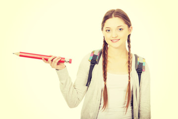Schoolgirl pointing aside with pencil.