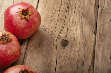 Ripe pomegranate fruit on a wooden table