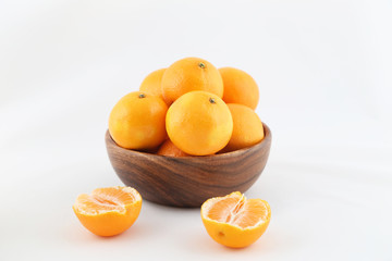 tangerines in a wooden bowl