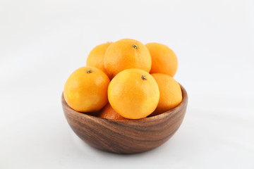 tangerines in a wooden bowl