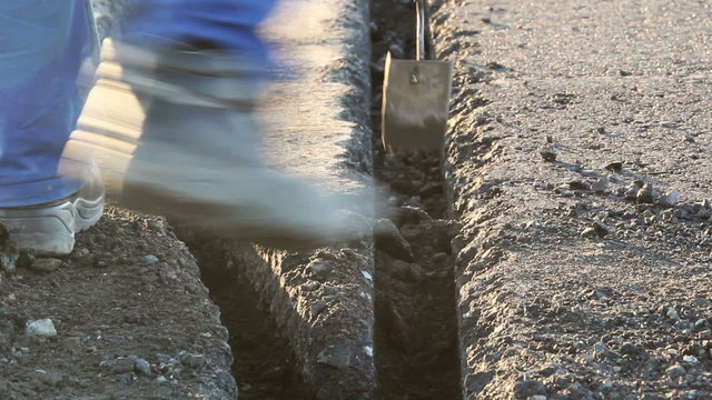 Worker dig trenches to lay cables for the airfield lighting system