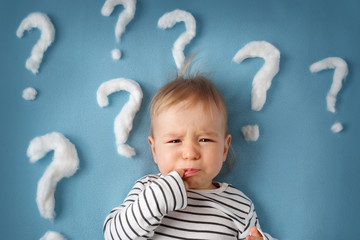 little boy with lots of question marks