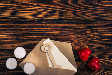 Two hearts, wooden key, and envelope, top view