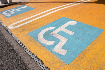 Handicapped parking areas sign in parking lot for disabled people on orange ground