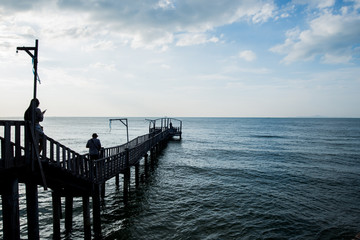 Bridge and pavillion on the sea with people walk on the bridge