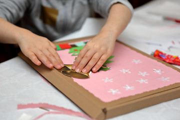 Child making decoration for Christmas