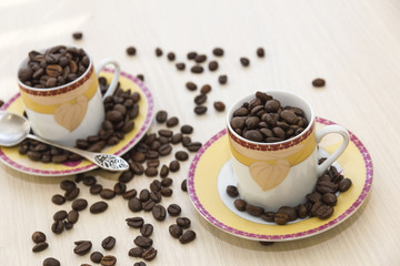 Cups, saucers and coffee beans.