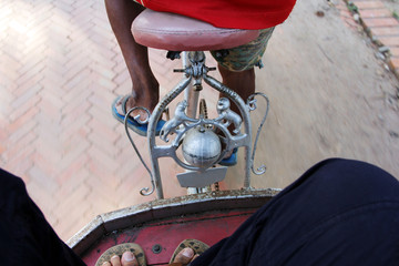 Tricycles / Toes stucking on the moving tricycles  during historical tour at Ayutthaya, Thailand