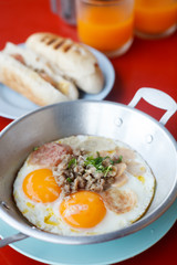 Egg Benedict in egg dish with bread