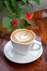 Cup of latte coffee on wooden table