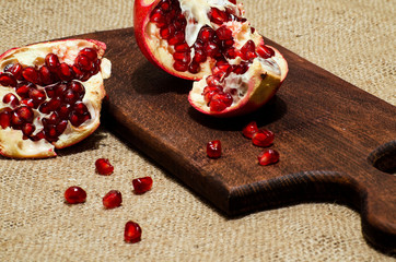 Pomegranate and pomegranate seeds on the kitchen blackboard