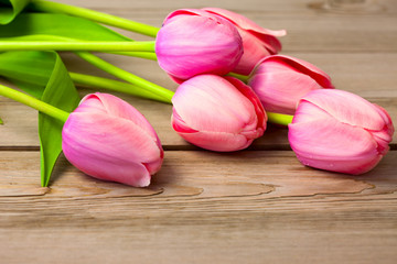 Bouquet of Fresh Beautiful Tulips on wooden texture